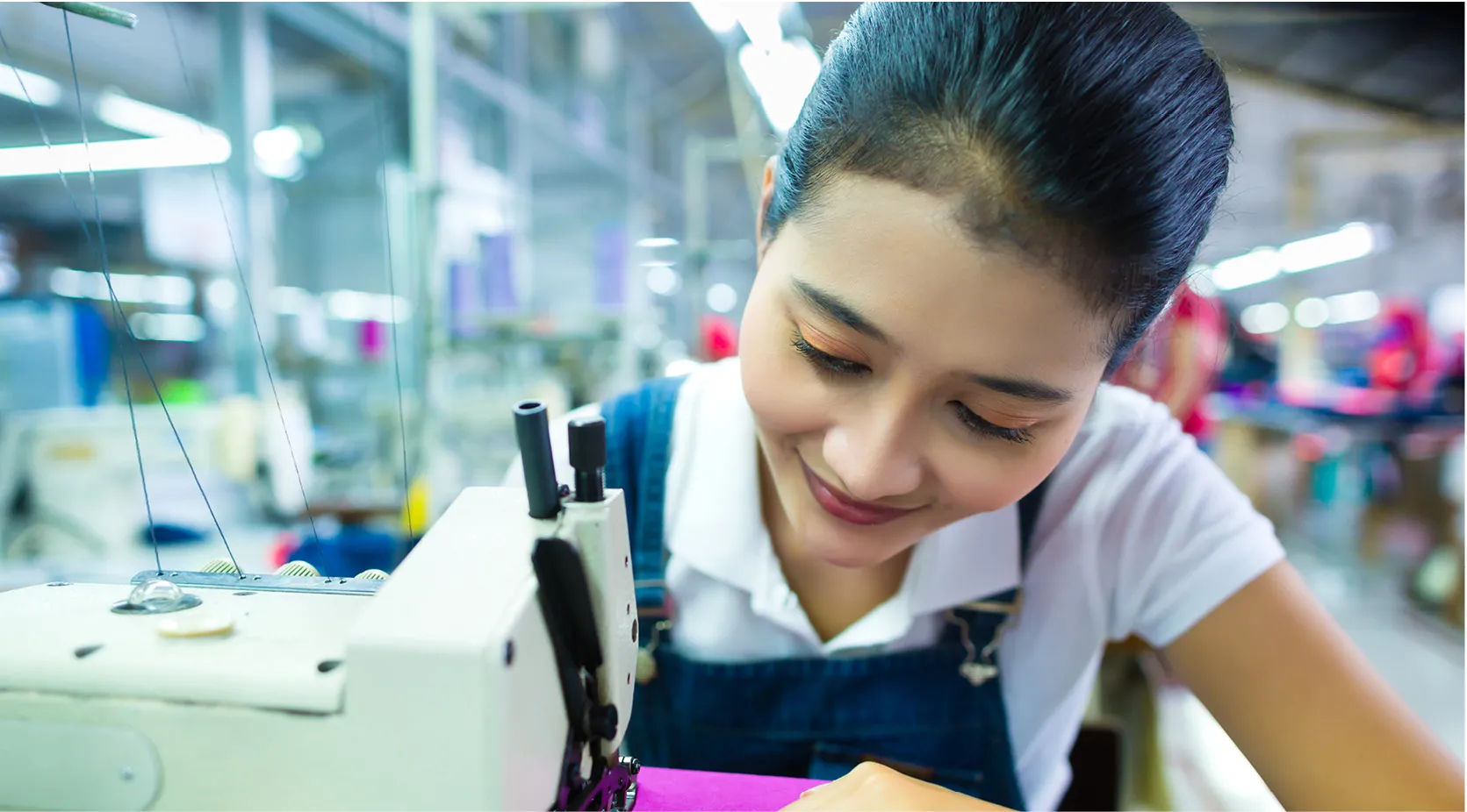 Woman sewing fabric on a machine, showcasing quality control for productivity.