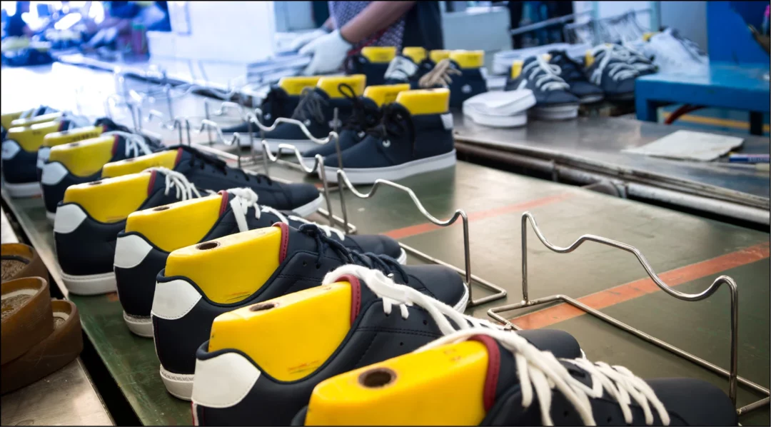 Shoes on a factory production line, illustrating vendor production management.