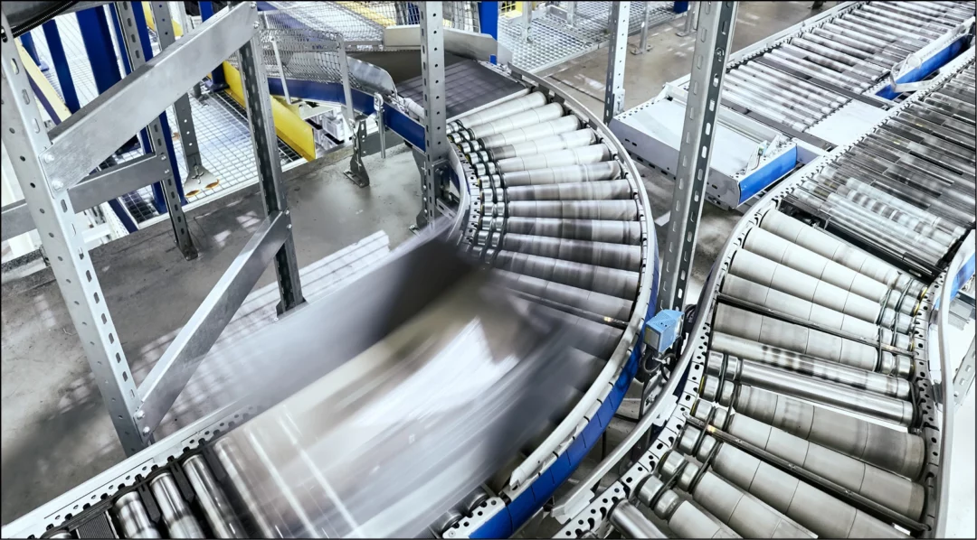 Automated conveyor belts in a warehouse, essential for production line quality checks.
