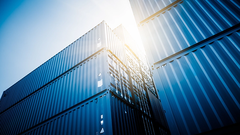 Stacked shipping containers symbolizing global logistics and supply chain management.