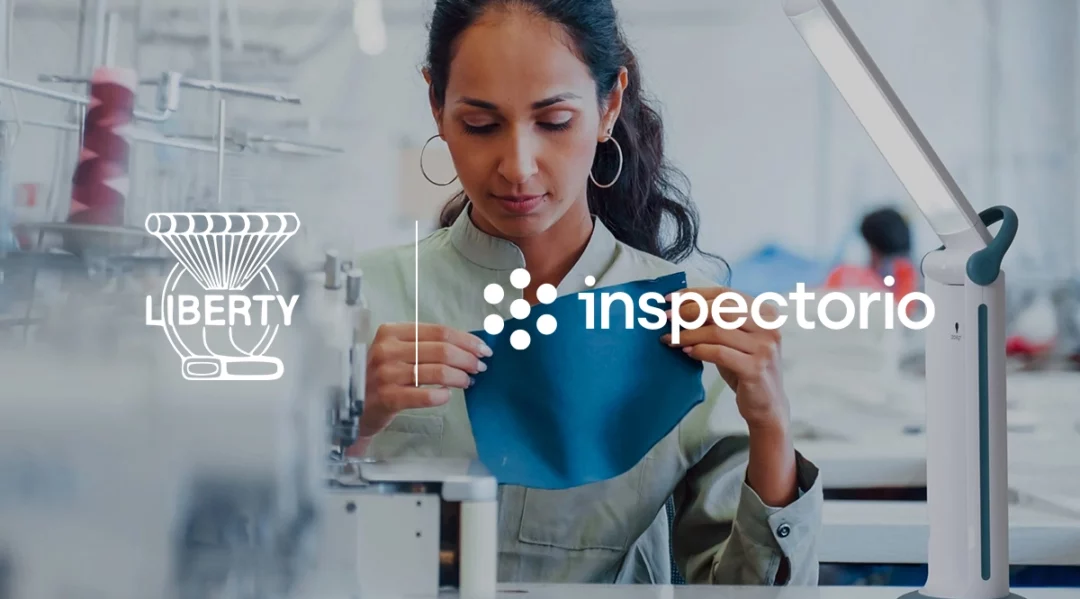 Liberty Mills digitalization: Woman inspecting fabric with Inspectorio logo