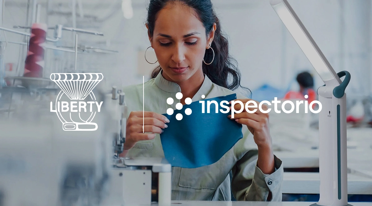 Liberty Mills digitalization: Woman inspecting fabric with Inspectorio logo
