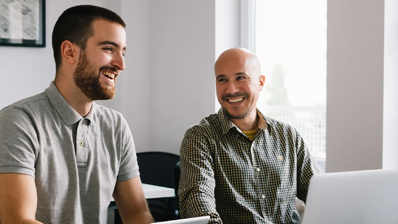 Two men smiling