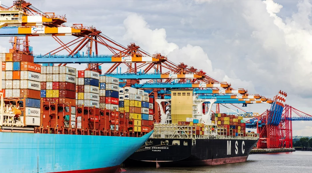 Large container ships at a busy port, showcasing global supply chain logistics.