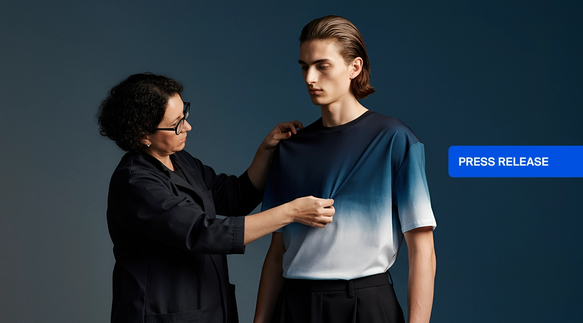 Designer adjusts ombre t-shirt on male model, "PRESS RELEASE" button