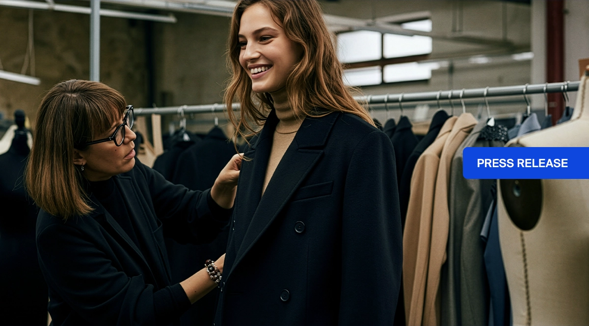 Fashion designer fitting a coat on a model, Mango quality control