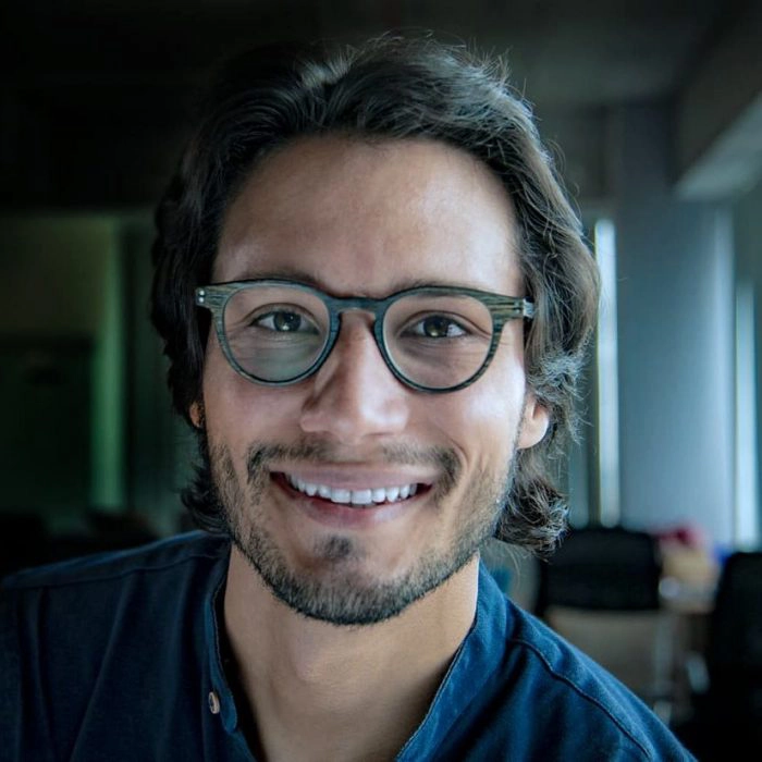 David Klein, a man with dark hair and glasses, smiles warmly.
