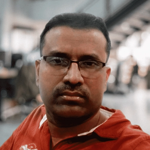 Areeb Ahmed wearing glasses and a red shirt